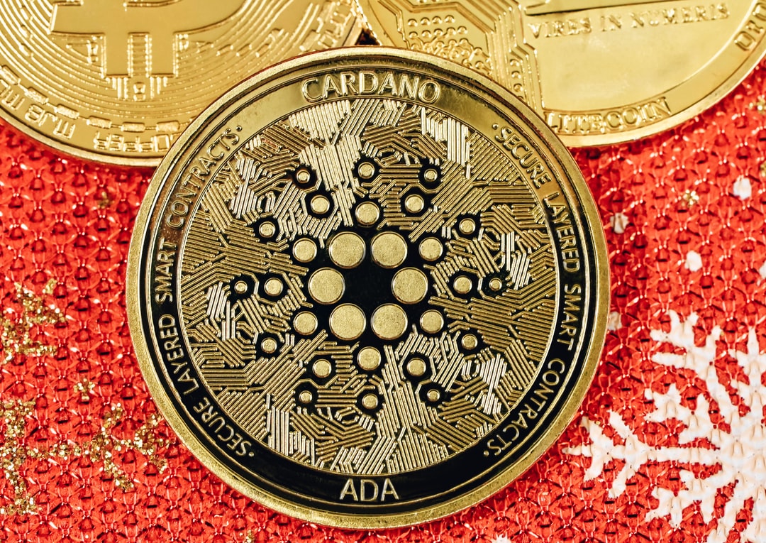An ADA coin on top of a red Christmas background, tags: gaming - unsplash